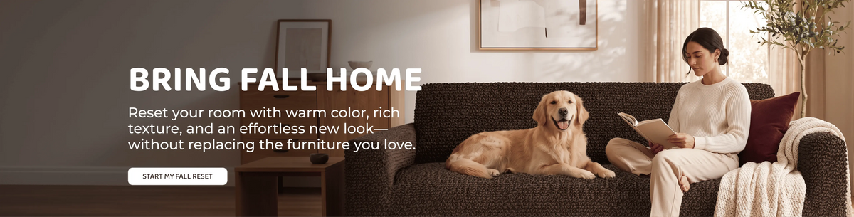 A woman sits on a dark brown sofa reading a book next to a golden retriever dog in a cozy, warmly lit living room. Large text on the left reads 'BRING FALL HOME' with a subtitle about resetting the room with warm color and rich texture.